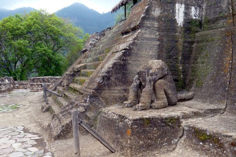 Headless Jaguar statue at the foot of the steps.