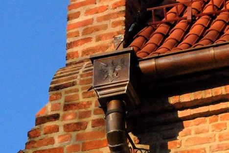 The image is pressed into the metal downspout