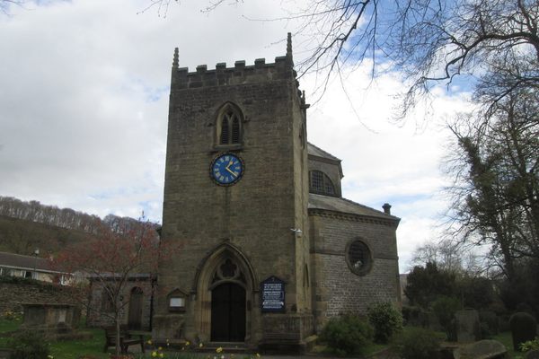 A stone clock tower is the entrance of an octagonal church