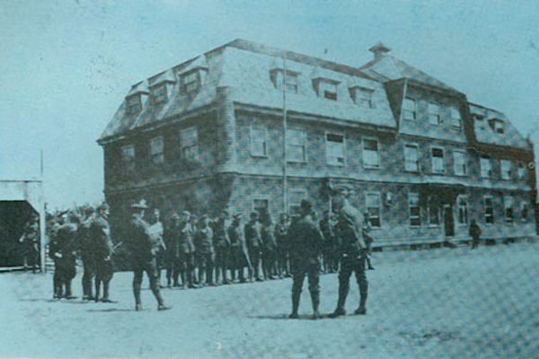 Army drills in front of the Crown Hotel. Designed by W.C. Harris, architect, this was meant to be the working man's hotel. It was less luxurious but still far above most hotels of the day. In 1916 the 185th Battalion was stationed at Broughton. The town had been deserted, but had fine quarters for the military: officers and the hospital were in the Broughton Arms; the non-commisioned officers at The Crown Hotel; and the enlisted men in the forty-three cottages that had been built for miners.